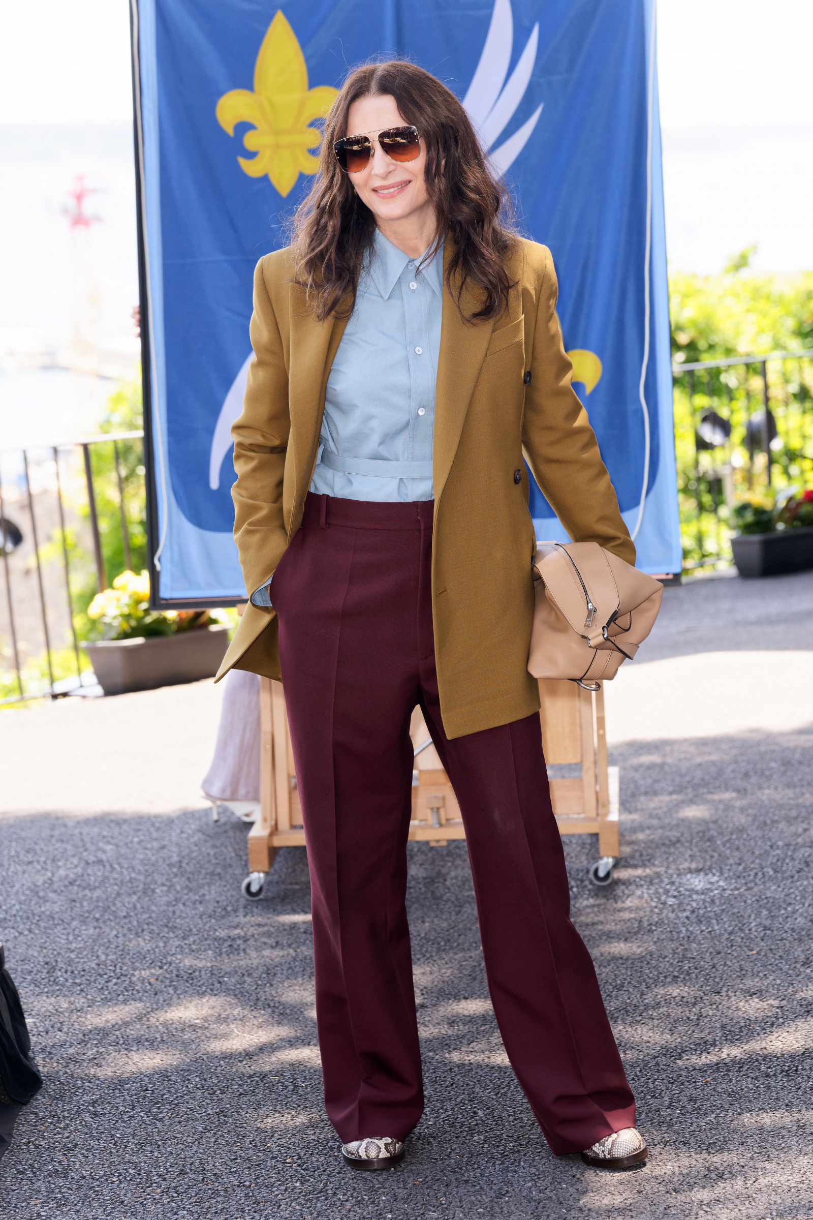 Juliette Binoche podczas 78. Festiwalu Filmowego w Cannes w maju lansowała najmodniejsze spodnie jesieni 2025, czyli bordowe dzwony (Fot. Sylvain Lefevre/Getty Images)